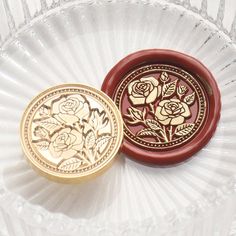 two decorative plates sitting on top of a glass plate