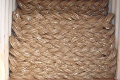 a close up of a rope on the side of a building with wood flooring