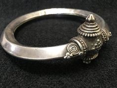 Bracelet ~ Vintage Bangle, Armband Tribal Silver Vintage 1910 I always enjoy collecting treasures, I find over the years it is harder and harder to sell them. Because of the replacement cost and just trying to find these vintage treasures. Antieke holle tribal zilveren armband (Kadla of Kadiya) uit Rajasthan India. Old Tribal Silver bangle from Rajasthan. Made of good silver, and hollow inside. This is an old and worn bracelet with a great patina. Yes ~ along with basic simplicity ~ It's all abo Cheap Traditional Hand-strung Bracelets, Bassali Jewelry, Jupiter Jewelry, Silver Bangle Bracelets Cuffs, Hindu Jewelry, Baseboard Styles, Silver Baubles, Statement Piece Jewelry, Silver Jewelry Accessories