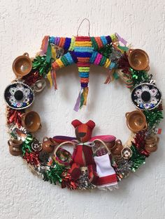 a wreath made out of various items hanging on the wall