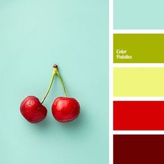 two cherries sitting on top of each other next to a color swatch with different shades