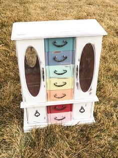 a multicolored cabinet sitting in the grass