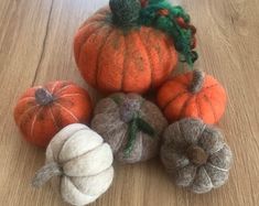 several small pumpkins on a wooden table