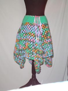 a mannequin wearing a skirt made out of crocheted granny's squares