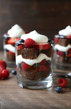 a dessert dish with strawberries, bananas and other toppings in a glass bowl