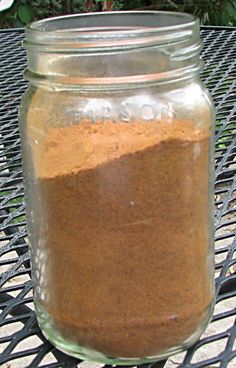 a jar filled with brown stuff sitting on top of a table