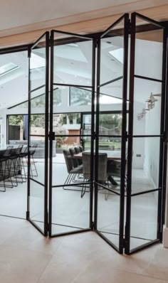 an open living room and dining area with glass doors