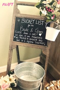 a bucket list sign sitting on top of a wooden stand next to a metal pail