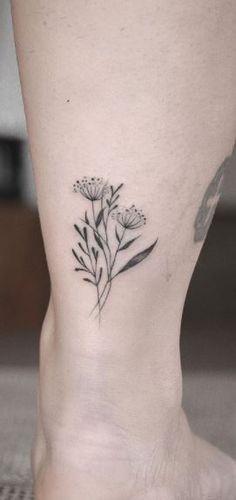 a small flower tattoo on the ankle