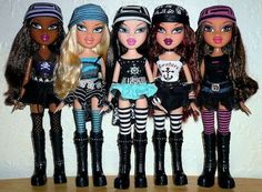 five dolls are lined up in different outfits and hair styles, all wearing pirate hats