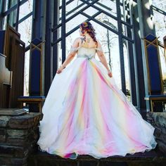 a woman in a wedding dress standing on some steps