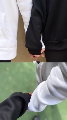 two people are holding hands with one person wearing a white shirt and the other in black