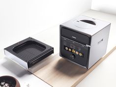 a toaster oven sitting on top of a counter next to a potted plant