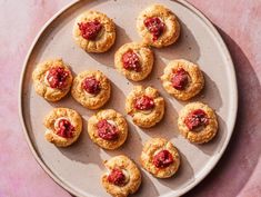 small cookies with strawberry jam are on a plate