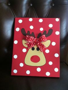 a red and white polka dot card with a reindeer's head on it