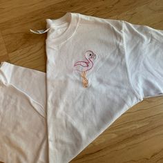 Love This Flamingo Design! Stitched On A White Short Sleeve Youth Medium Tee. I Recently Closed My Embroidery Business And Selling Off All My Sample Shirts. These Are In Great Condition, Brand New! Embroidered With High Quality Thread! Cute Pink T-shirt With Machine Embroidery, Cute White T-shirt With Machine Embroidery, Cute White Tops With Embroidered Logo, Cute White Top With Embroidered Logo, Spring Tops With Custom Embroidery, Cute White Tops With Machine Embroidery, Cute White Top With Machine Embroidery, Cute White T-shirt With Custom Embroidery, White Cute T-shirt With Custom Embroidery