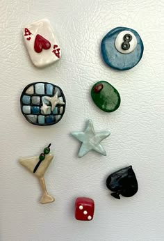 a refrigerator with magnets on the side of it and different colored objects attached to it