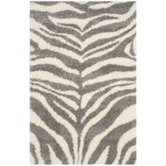 a rug with zebra print in grey and white colors on the floor, it is very soft