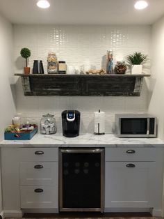 a kitchen counter with two microwaves and a toaster oven