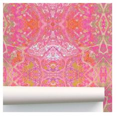 pink and gold wallpaper with an abstract design in the middle, along with a roll of white paper