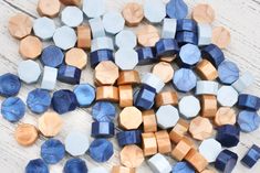 blue and brown pieces of wood sitting on top of a white wooden table next to each other