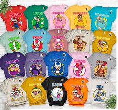 many different colored shirts with cartoon characters on them