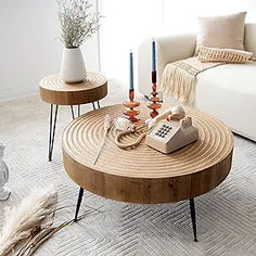 a living room with two coffee tables and a couch in front of a large window