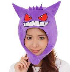 a woman wearing a purple hat with red eyes and an angry cat design on it