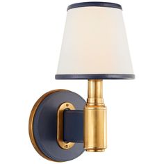 a blue and gold wall light with a white shade on the top of it's arm