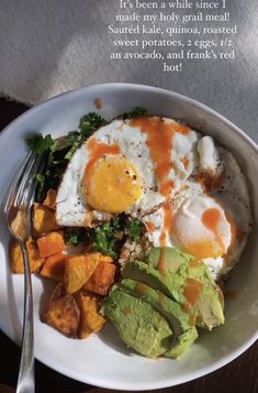 a plate with eggs, avocado and other food on it next to a fork