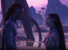 two alien women standing next to each other in front of palm trees and mountains at sunset