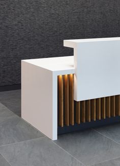 a white counter sitting on top of a tiled floor