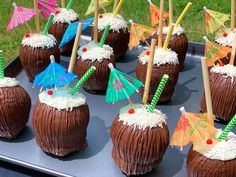 there are many chocolate coconuts with umbrellas on them