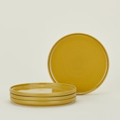 three yellow plates stacked on top of each other