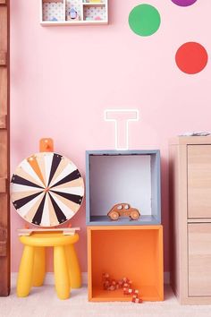 a child's room with pink walls and toys