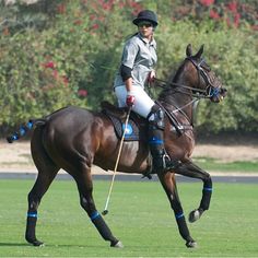 a man riding on the back of a brown horse