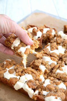 a person holding a piece of cake with marshmallows on it and topping