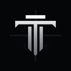 a cross with the word t on it in white and black font, against a dark background