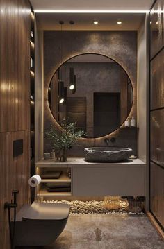 a bathroom with a round mirror above the sink and a bathtub next to it