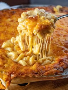 a spoonful of macaroni and cheese being lifted from a casserole dish