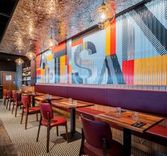 the interior of a restaurant with tables and chairs