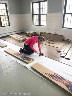 a woman in pink shirt laying on floor next to boxes with american flag designs on them