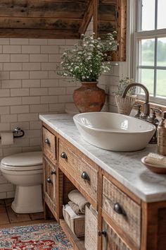 a bathroom with a sink, toilet and rug on the floor in front of it