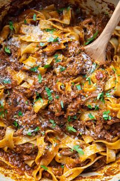 a skillet filled with pasta and meat sauce