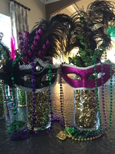 two mardi gras masks sitting on top of a table