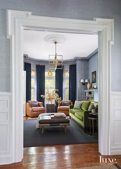 a living room filled with furniture and blue walls