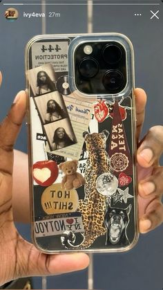 a person holding up a cell phone case with pictures on it and stickers all over the back