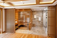 a wooden sauna in the middle of a room with wood flooring and walls