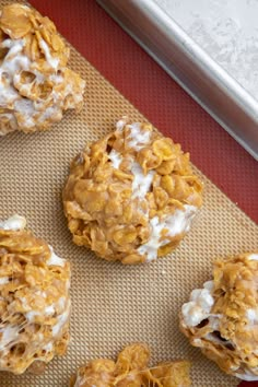 four cookies are sitting on a baking sheet