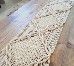 a woven table runner sitting on top of a wooden floor